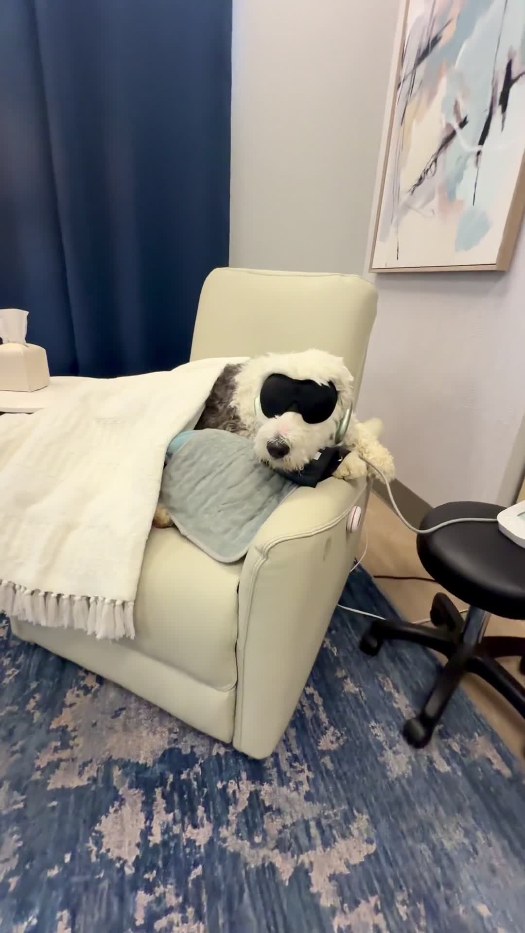 Wilma resting in a Music City Ketamine infusion chair with an eye mask and blanket